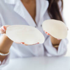 Female doctor choosing mammary prosthesis in the office.